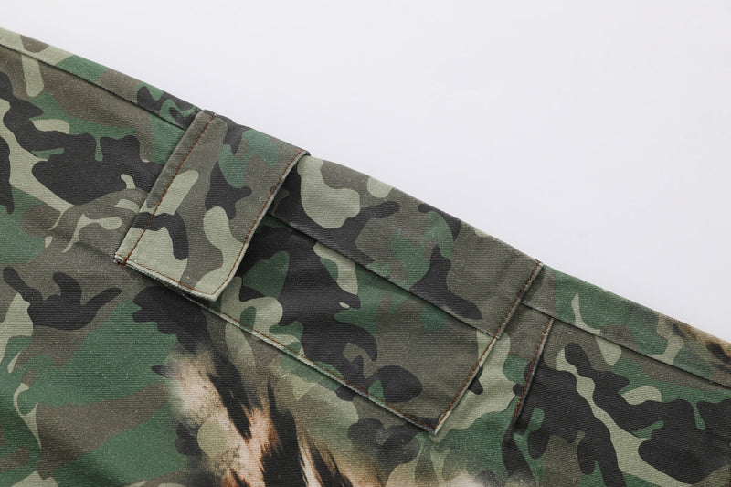 Close-up of a cargo side flap pocket on green camouflage and leopard print pants