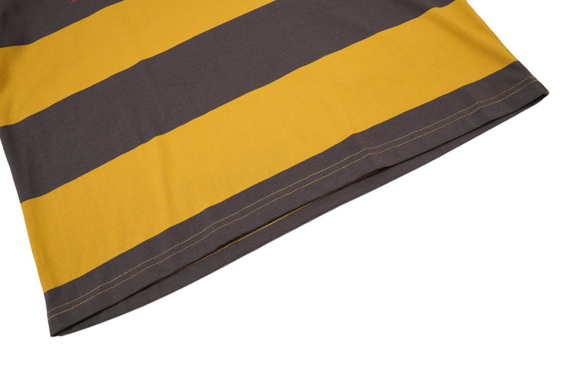 Close-up of a mustard yellow and charcoal striped rugby polo hem with visible stitching and soft cotton texture