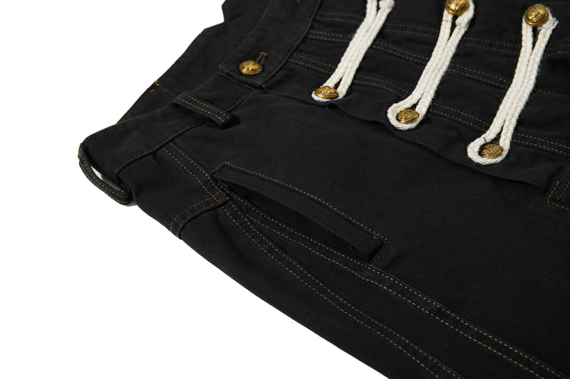 Close-up of black front panel with rope closures, pocket edge, and contrast stitching
