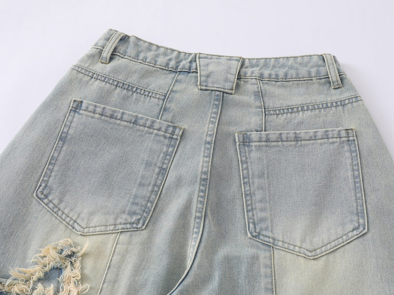 Back waist close-up showing belt loops and patch pockets on light wash jeans