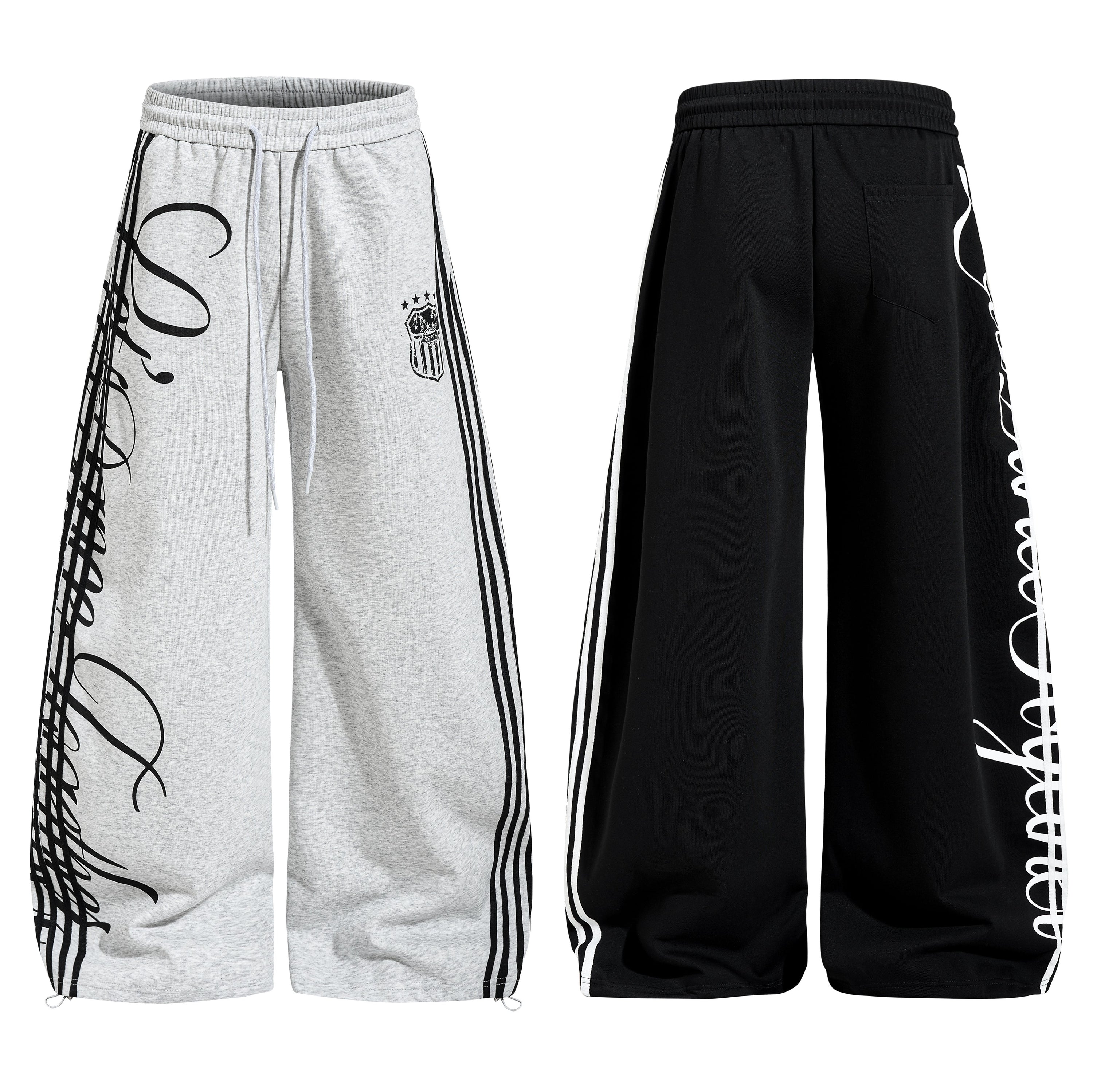 Heather grey wide-leg sweatpants with black oversized script print and three contrast side stripes, front view