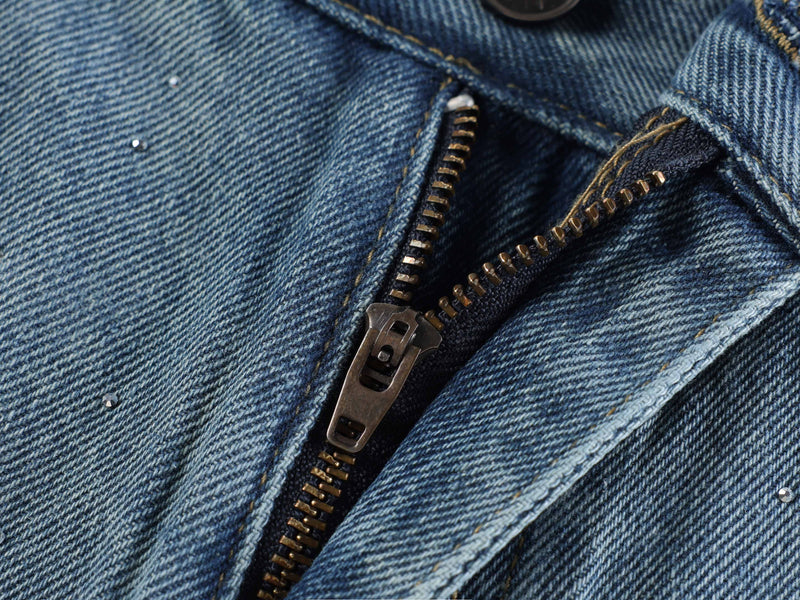 Light blue zipper fly close-up on rhinestone-speckled denim