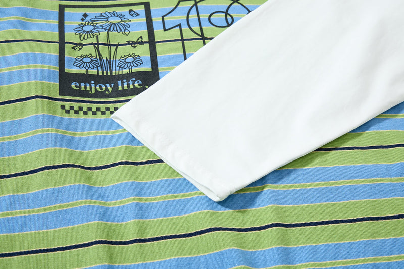 Close-up of front graphic and white sleeve on green striped polo shirt