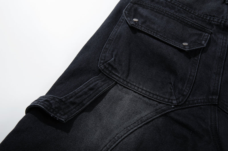 Close-up of side cargo pocket and panel seams on black distressed jeans