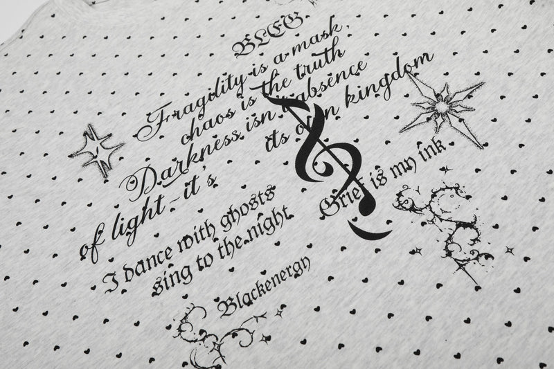 White graphic tee with allover black micro heart print and gothic script featuring a large treble clef and star accents