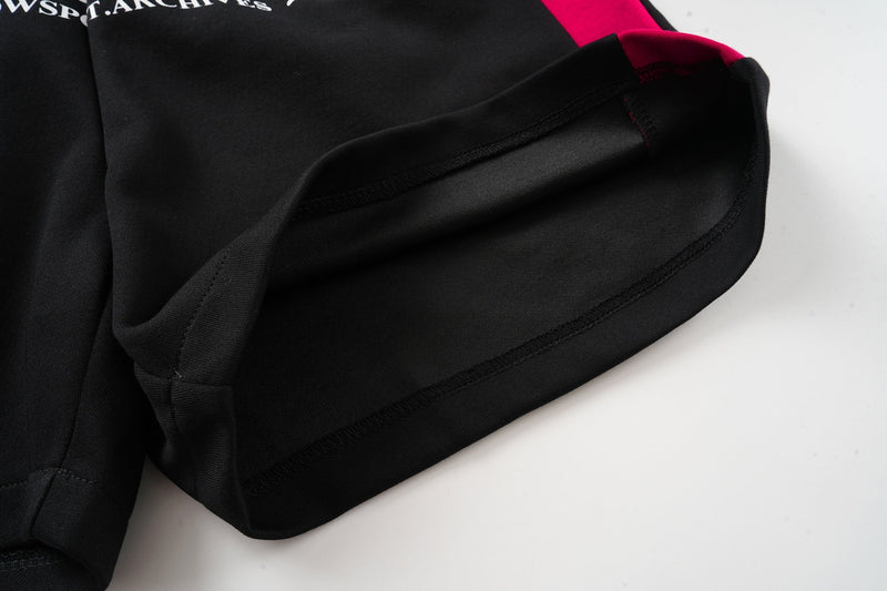 Close-up of black hem and stitched cuff on the leg opening