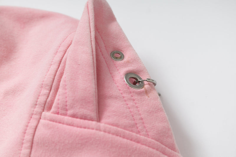 Close-up of pink hoodie hood side with metal eyelets and snaps