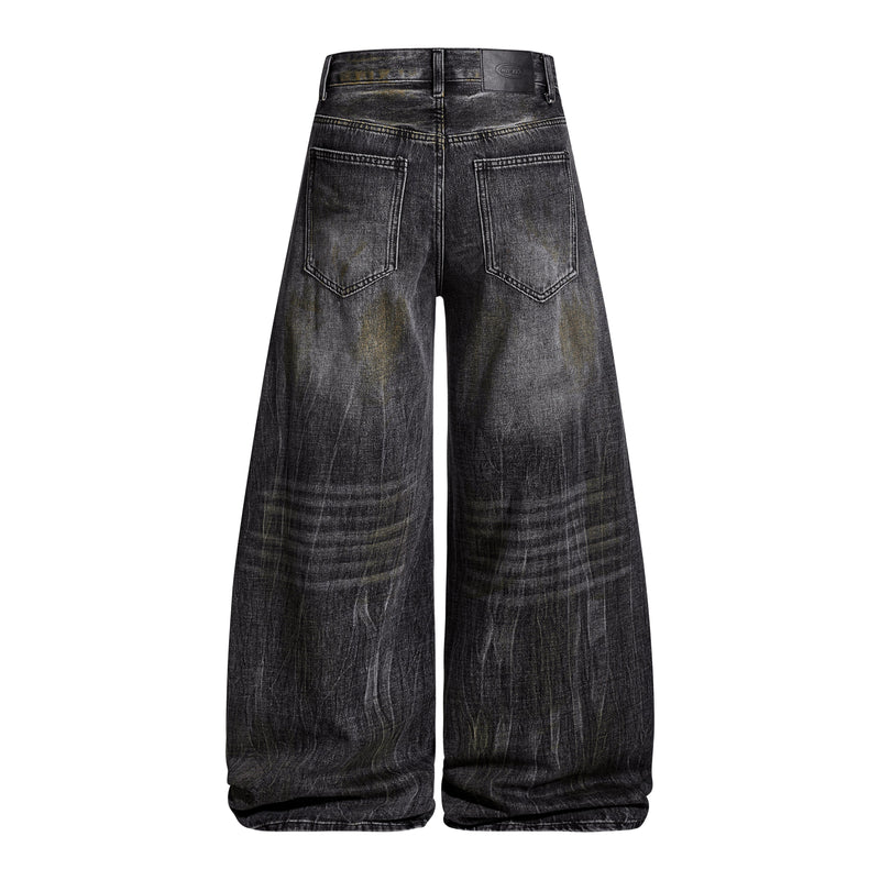 Back view of black washed wide-leg denim pants with two patch pockets and leather waistband label