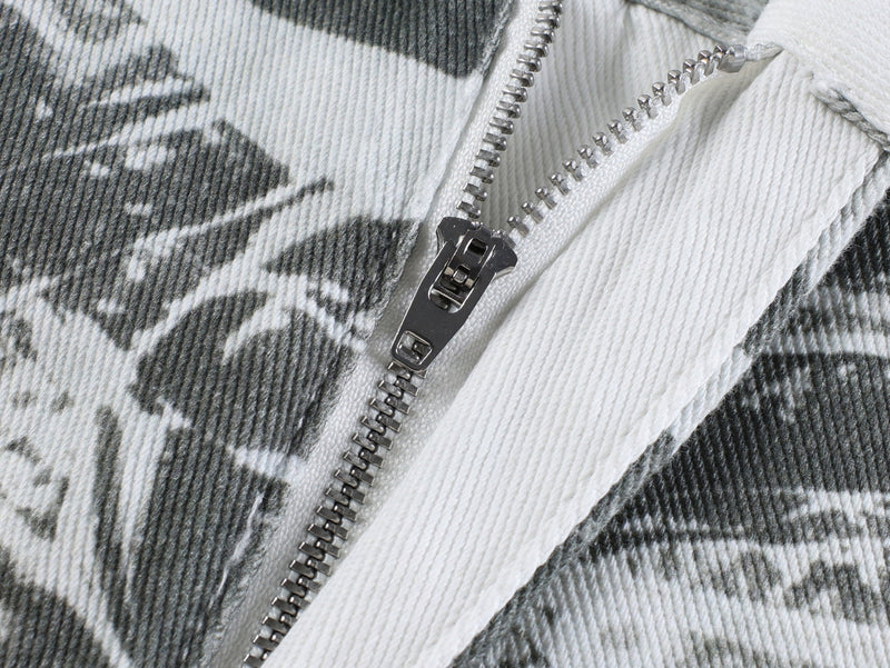 Close-up of metal zipper on gray printed pants fabric