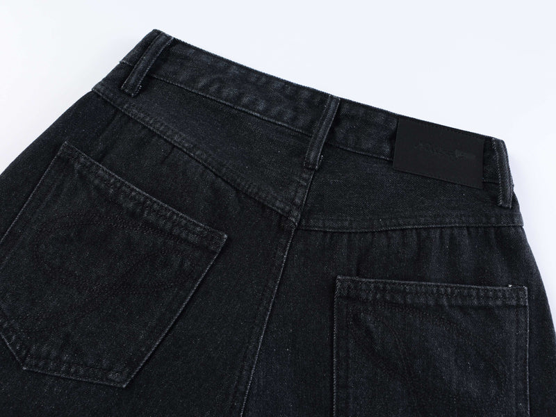 Back waistband detail of black denim shorts with logo patch and topstitching