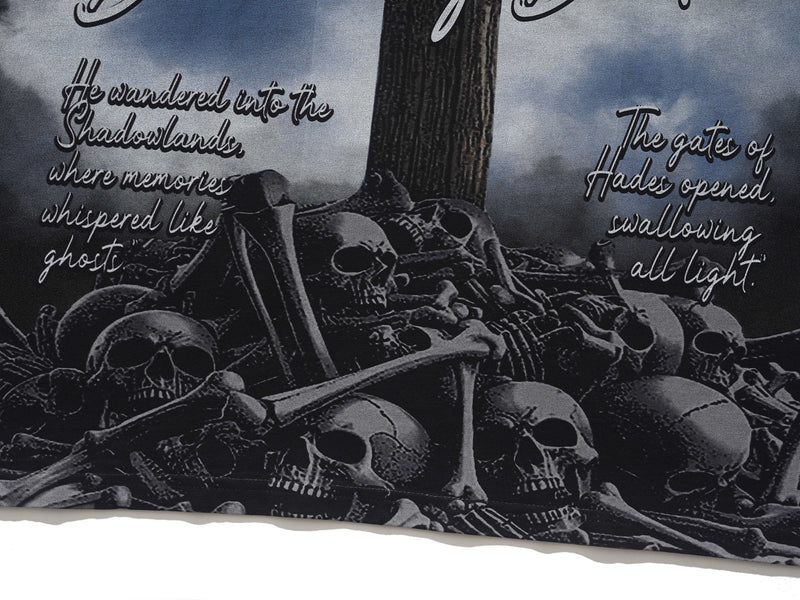 Gothic skull graphic tee with piled bones and eerie shadowland text in dark monochrome streetwear style