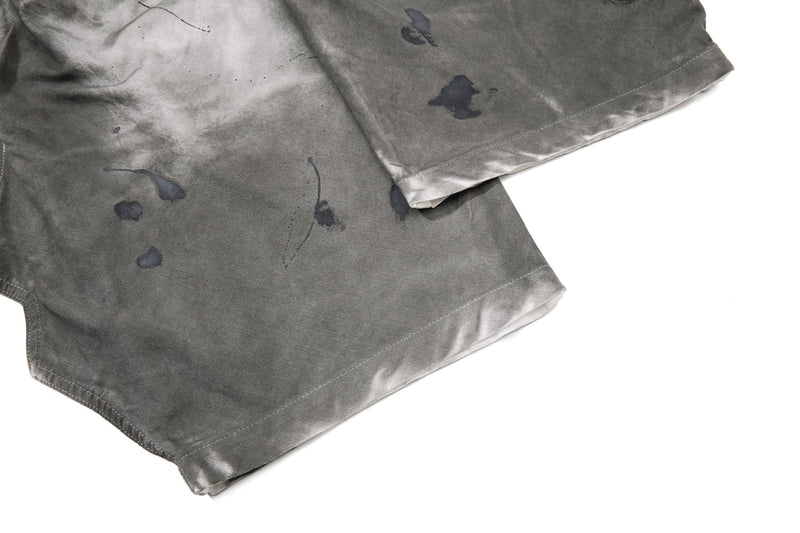 Close-up of hem and lower leg on gray jeans with dark wash shading