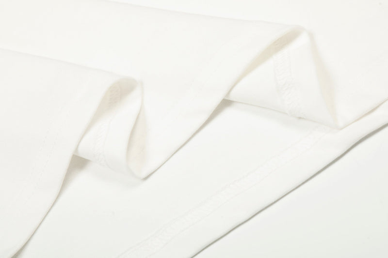 Close-up of white fabric folds showing soft cotton texture and stitching