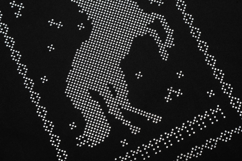 Black T-shirt close-up with a shimmering rhinestone horse graphic in a western streetwear style