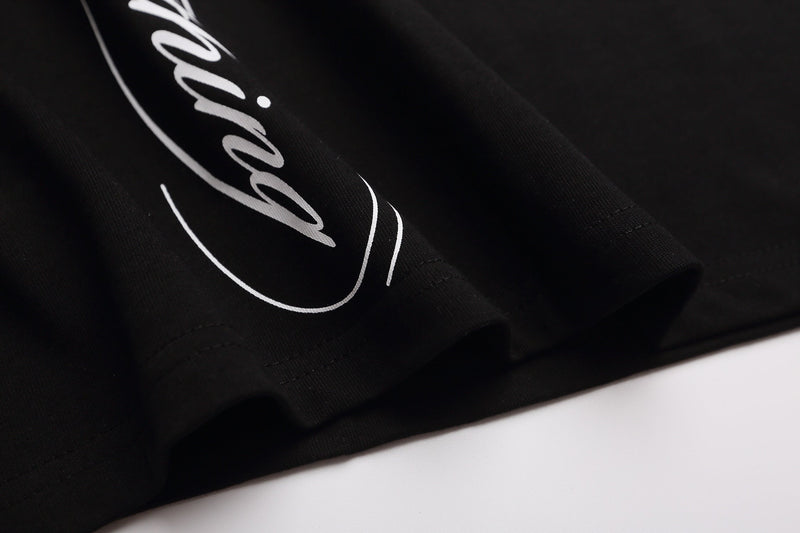 Black raglan tee with white gothic script graphic and star detail on soft cotton fabric