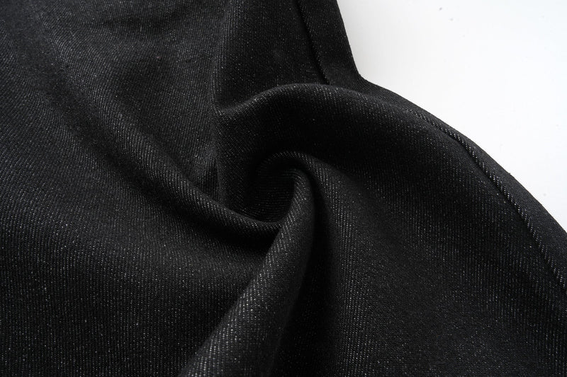 Close-up of black denim fabric texture and fold