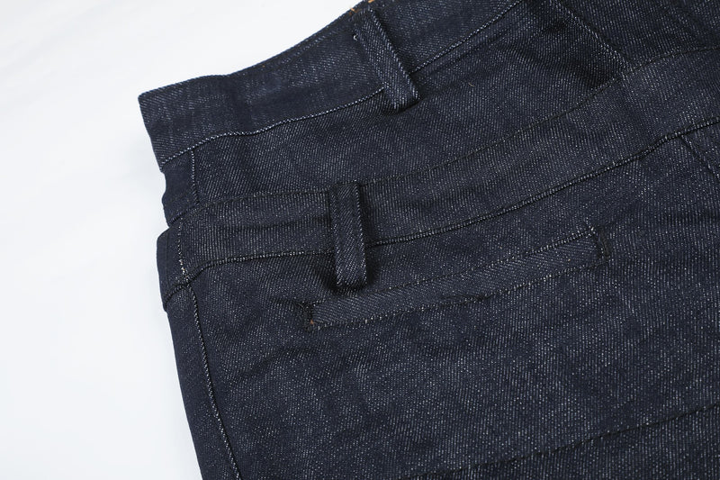 Close-up of dark jeans back waist with belt loop and topstitching