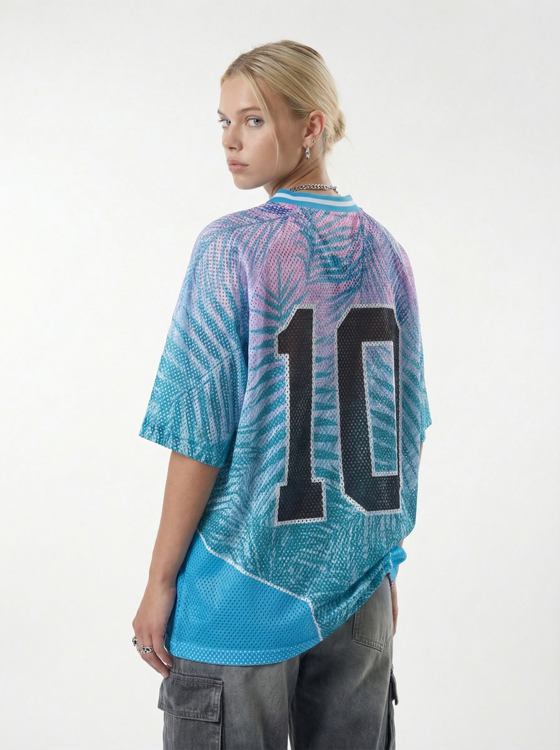 Model wearing a blue and purple mesh jersey T-shirt with a large number 10 on the back, paired with gray cargo pants