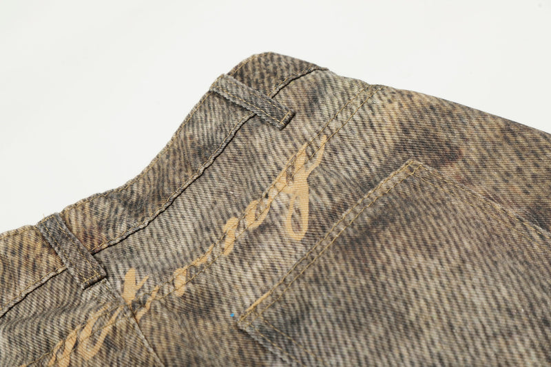 Close-up of back waistband and pocket seam on leopard wash denim
