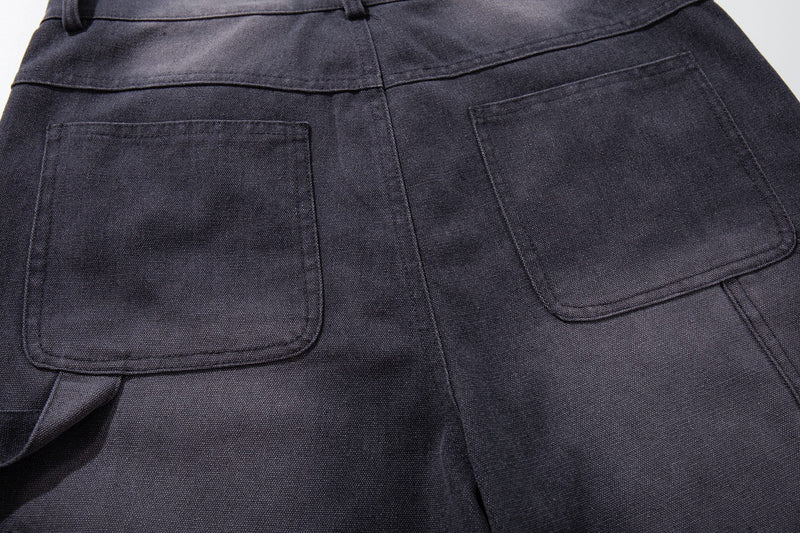 Close-up of back patch pockets on dark denim shorts with cargo pocket detail