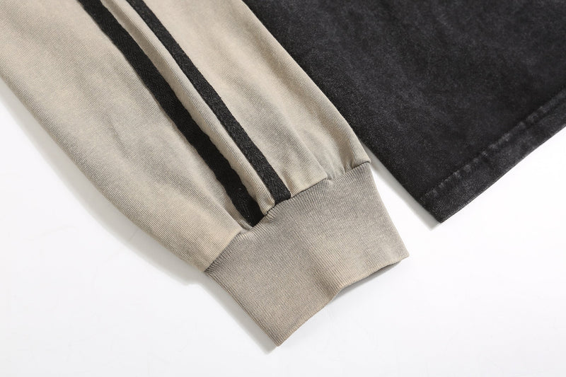 Close-up of beige sleeve cuff and side stripe on rugby polo sweatshirt