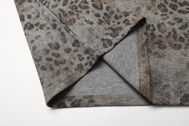 Close-up of oversized leopard print polo tee with grey knit fabric and stitched hem detail