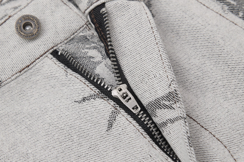 Close-up of front fly zipper and button on gray brushstroke-print denim