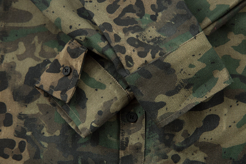 Close-up of folded collar and sleeve cuff on camo leopard overshirt