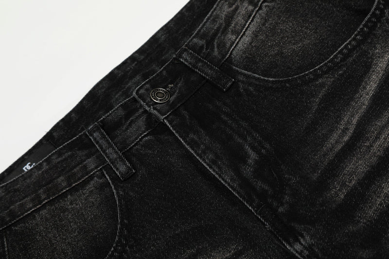 Close-up of black jeans front waistband and button detail