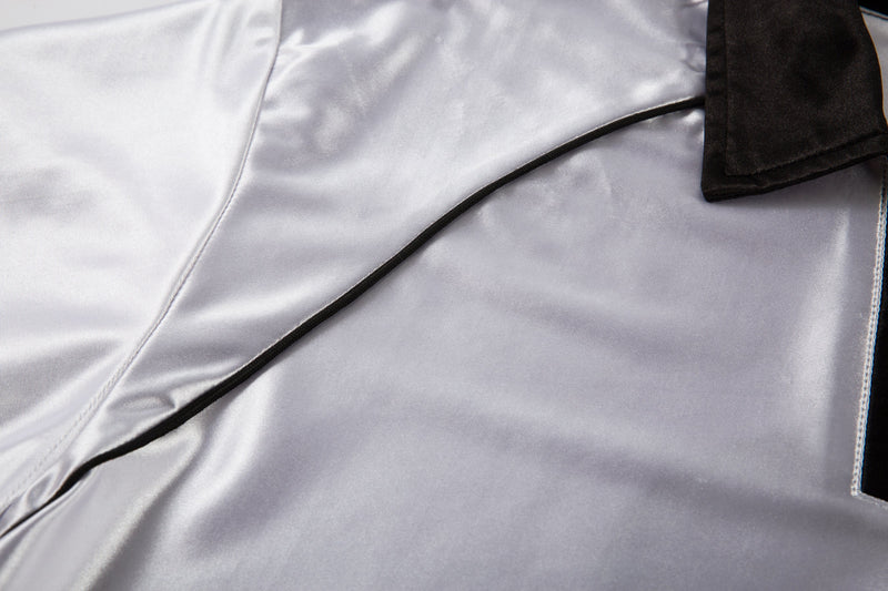 Close-up of white jersey shoulder seam and black piping detail
