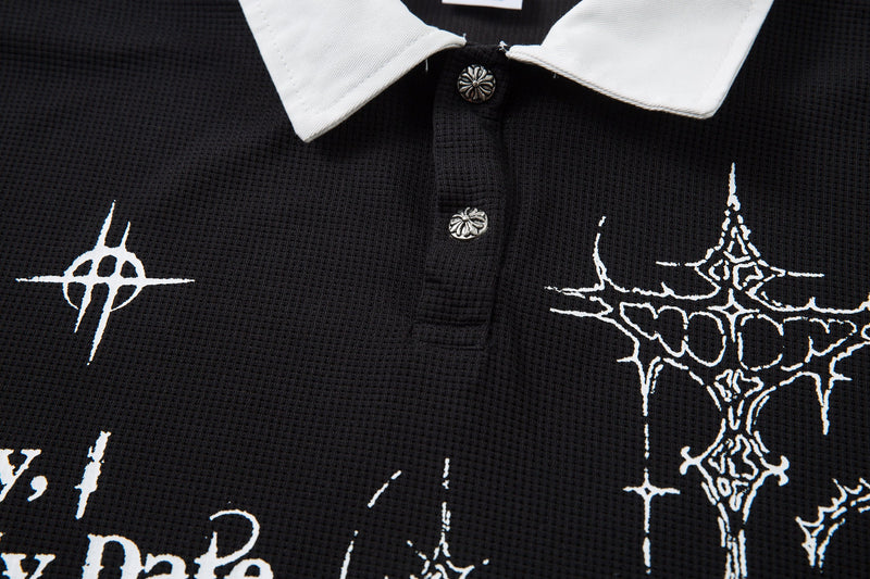 Black gothic polo shirt with white collar, button placket, and thorny cross graphics on textured fabric