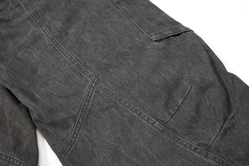 Dark gray cargo pant lower leg detail with curved seam lines