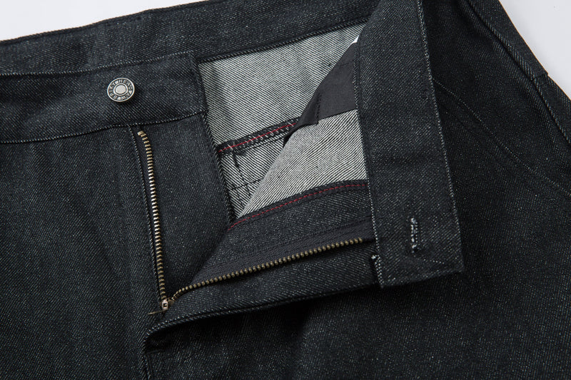 Close-up of the front fly opened to show zipper, pocket lining, and waistband detail