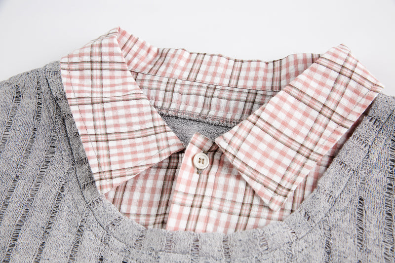 Close-up of pink plaid collar and button on gray mesh top