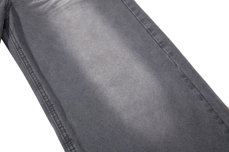 Close-up of charcoal denim leg panel with faded wash