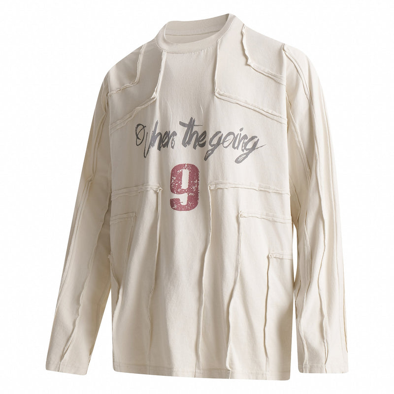 Cream long sleeve tee with deconstructed patchwork seams and front graphic text