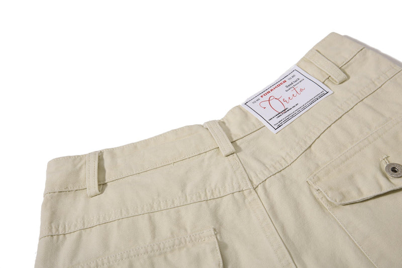 Close-up of beige cargo pants back waistband label and belt loops