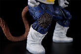 The Seakoff Great Ape Vegeta Collectible Figure showcases the detailed lower body and legs of the Dragon Ball Z character. It features blue pants with fur, white boots, and a long brown tail against a black background, embodying intricate details for fans. This premium 36cm action figure is a must-have!.