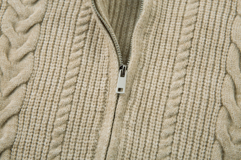 Close-up of beige cable knit jacket front zipper and knit texture