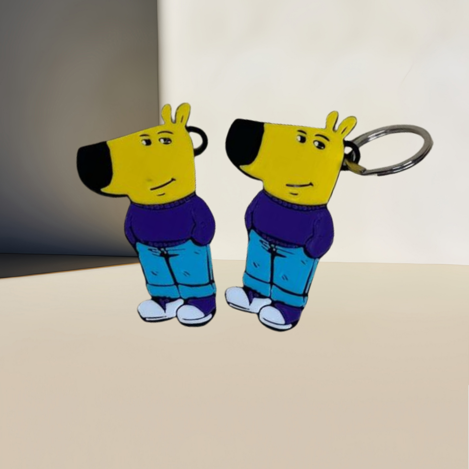 Two Chill Guy keychains from the 10-Piece Meme-Inspired Collection rest on a surface. They feature yellow heads, blue pants, and purple shirts; one is attached to a metal ring. Made of high-quality acrylic, they stand against a plain beige and gray blurred background.