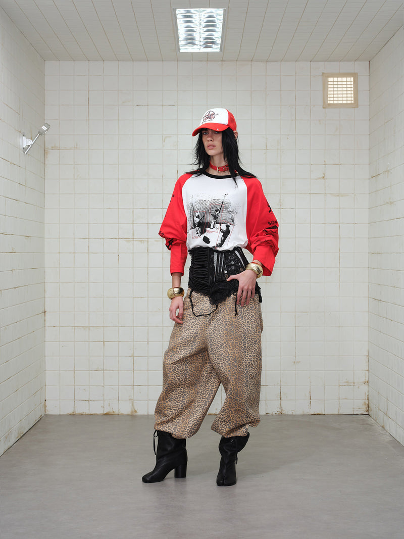 Model wearing red and white graphic raglan long-sleeve T-shirt in full body view