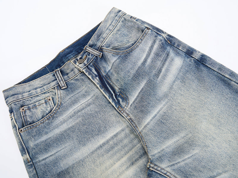 Close-up of front waistband and pocket area on faded blue wide-leg jeans