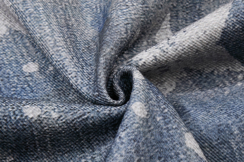 Close-up of folded denim fabric showing the jeans texture and star pattern