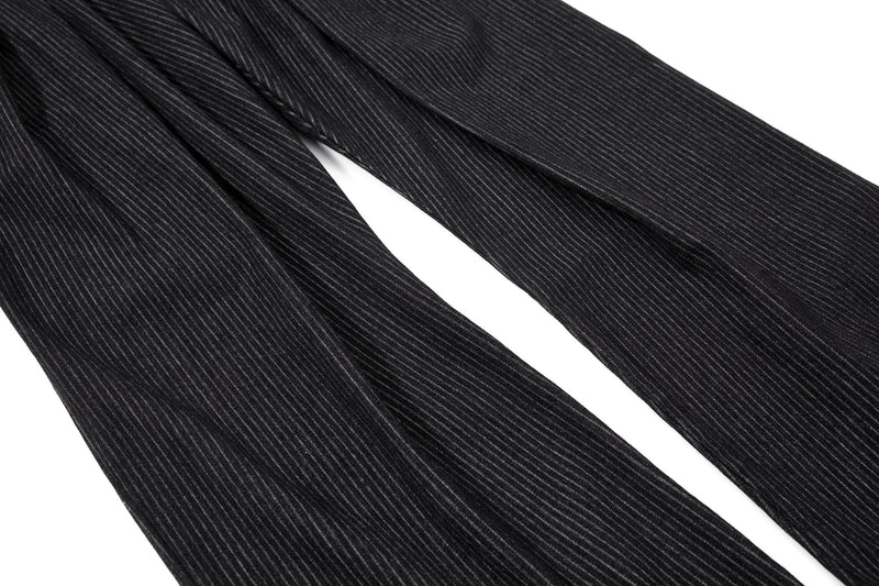 Black pinstripe trouser legs laid flat, wide straight cut