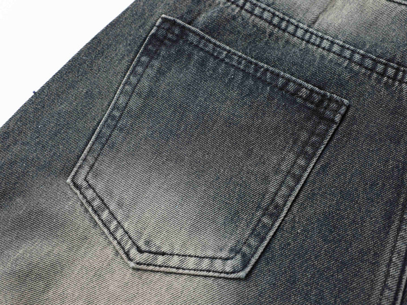Close-up of back pocket on black faded denim pants