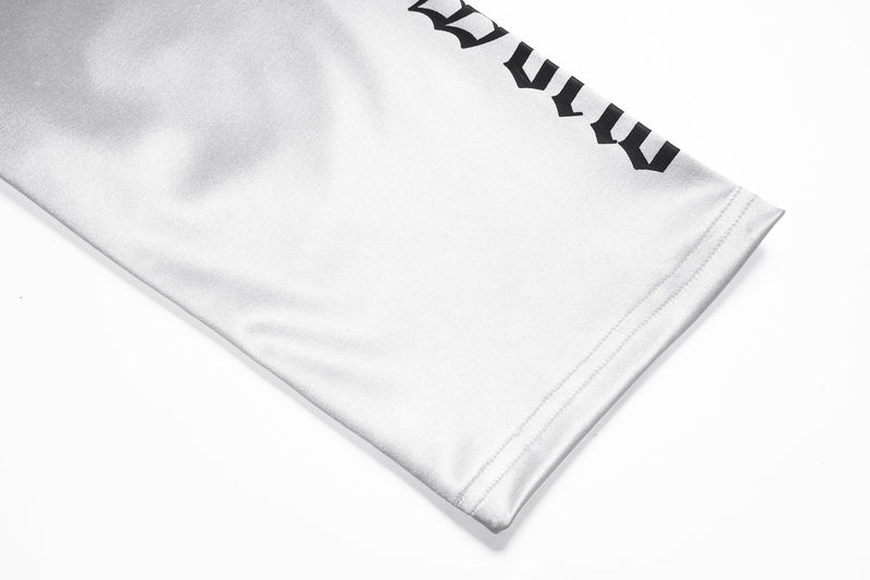 White sleeve cuff detail with printed black gothic lettering