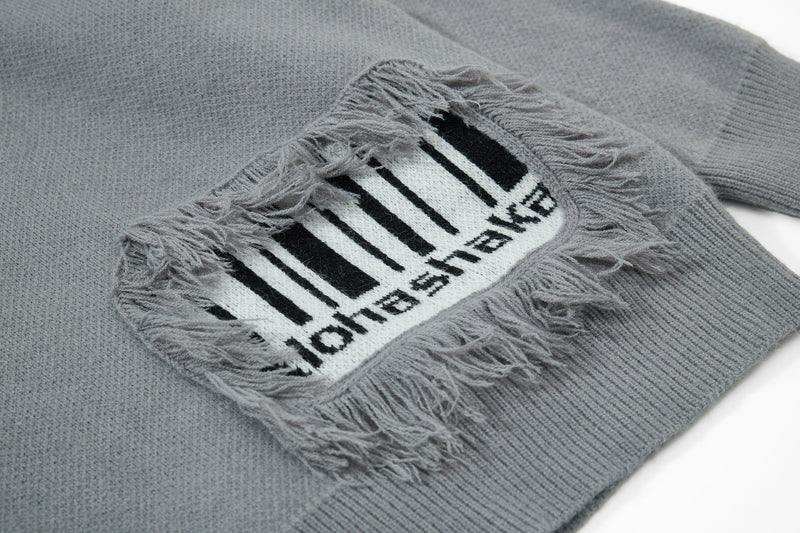 Gray knit sweater close-up of chest fringe patch with striped graphic
