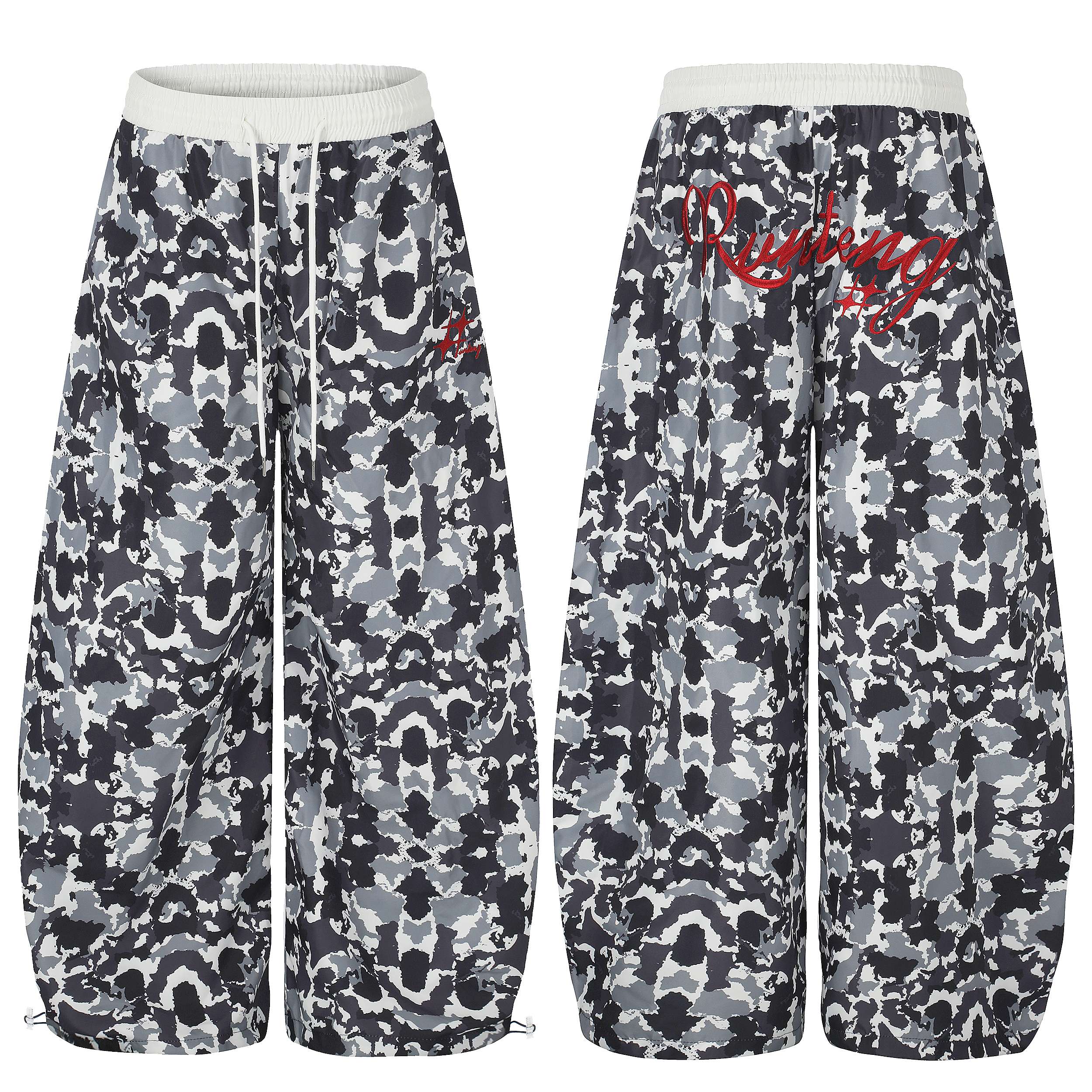 Front and back view of oversized abstract camo wide-leg sweatpants with white elastic waistband and red embroidered logo
