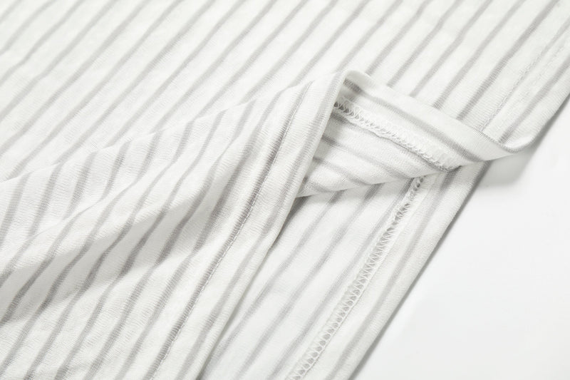 Close-up of white striped cuff and seam detail on hoodie tee