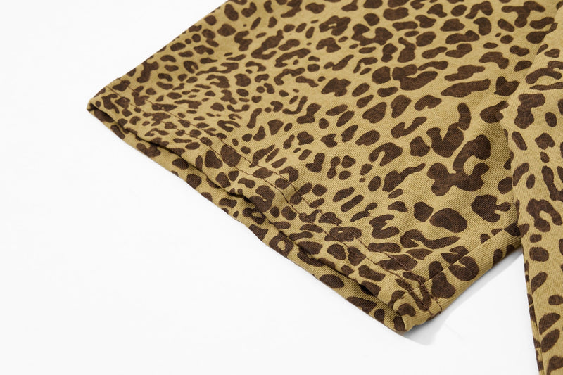 Close-up of a vintage leopard print polo tee sleeve in tan and brown Y2K streetwear style